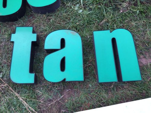 Green &#034;t,a,n&#034; Channel Letters, black trim, black channel