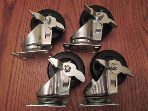 Set of 4 used locking brake swivel steel caster wheels 4&#034;x1 1/4&#034; black for sale