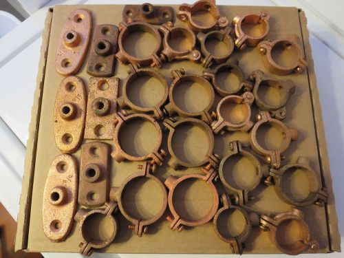 Assorted copper clad unused split ring pipe hangers &amp; wall plates for sale