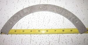 OILY SEWER Cast Aluminum Utility Sign Rocker pattern metal art