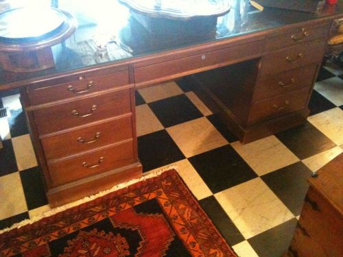 executive walnut desk partially unassembled.