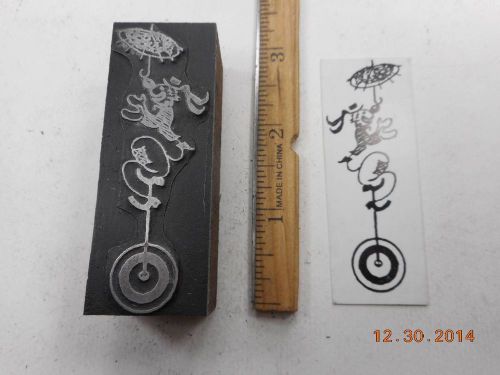 Letterpress Printing Printers Block, Circus Clown on Unicycle balances Umbrella