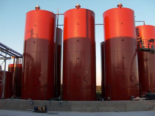 25,000 gallon vertical cone bottom storage tank with internal heating coil, used for sale