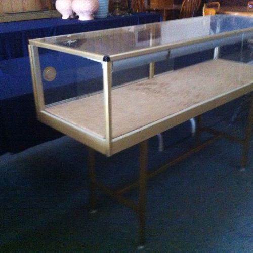 Vintage lighted glass countertop or floor display case with gold metal trim for sale