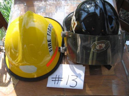 1 yellow  Cairns  fire  helmet and 1 black Cairns firehelmet