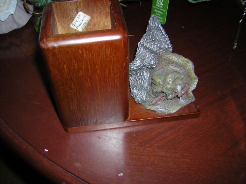 pencil holder wood square on platform that has a resing fishing hat and net