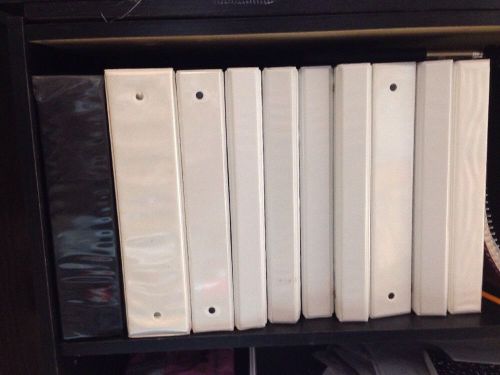 9 White Binders And One Black Binder